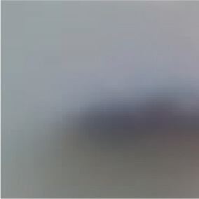 A blurred image with indistinct colors and shapes, making it difficult to identify any specific objects or details. The background appears to be light gray with a dark, unfocused area near the center.