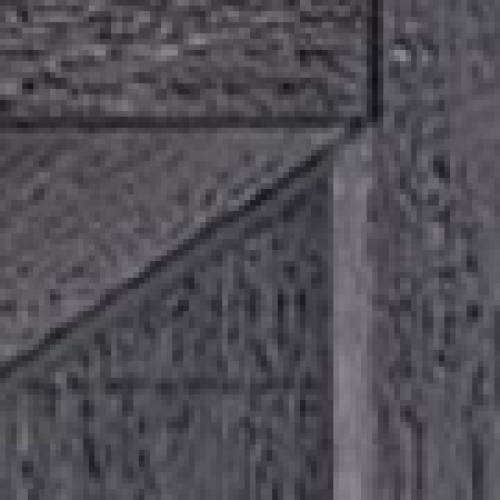 Close-up of a dark, textured wooden surface with geometric patterns formed by intersecting panels and visible wood grain.