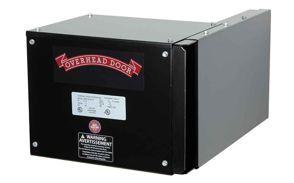 A black and gray Overhead Door commercial door operator, CDX model, garage door opener unit with a warning label and the brand logo on the front panel.