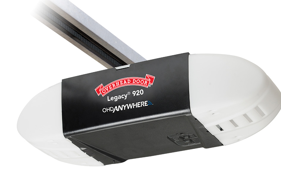 A close-up view of a Legacy garage door opener, featuring the Overhead Door Legacy 920s white and black housing with brand and model labels visible on the front.