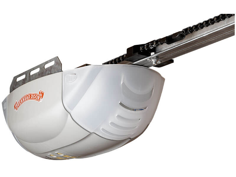 A close-up of an overhead garage door opener mechanism with a white plastic cover, chain drive, and the Overhead Door brand logo on the side.