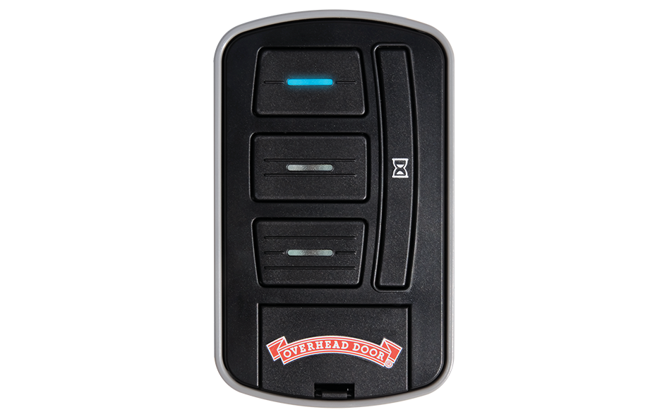 A black Overhead Door garage remote with three rectangular buttons, a blue LED indicator above the top button, an hourglass symbol on a side button, and the Overhead Door logo at the bottom—compatible with wireless wall console systems.